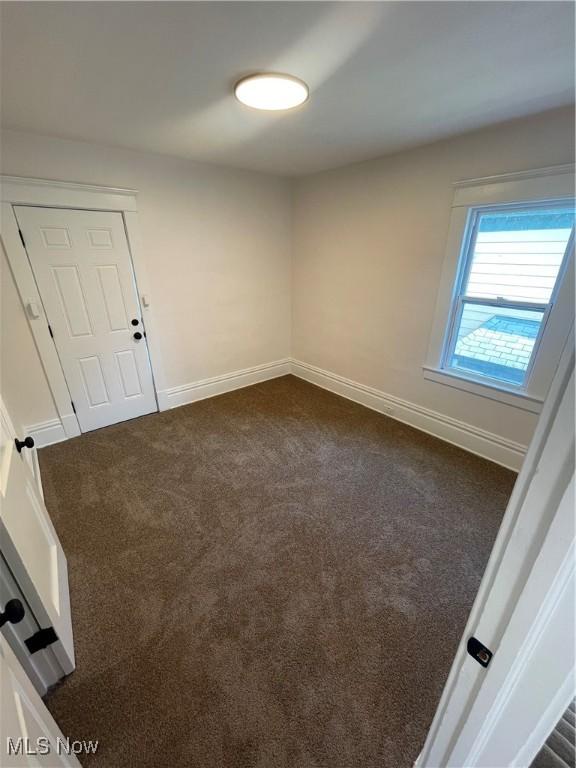 3363 E 125th St, Cleveland, OH 44120 - empty room with dark carpet and baseboards