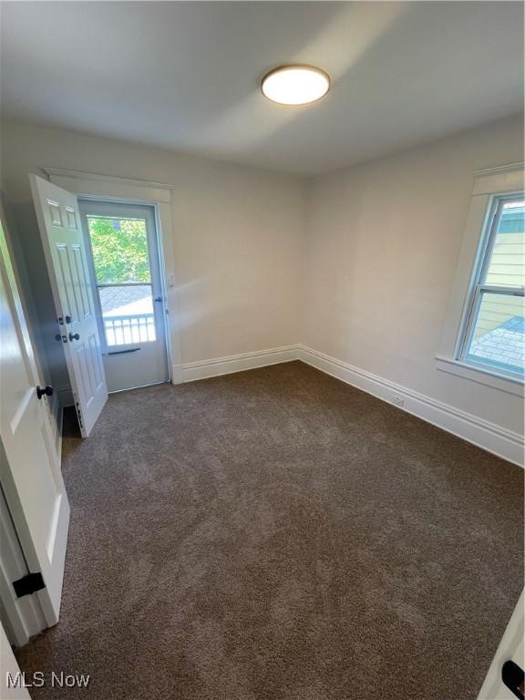 3363 E 125th St, Cleveland, OH 44120 - unfurnished room with dark carpet and baseboards