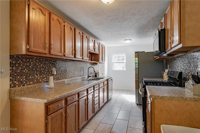 3917 Walker Rd, Walker, WV 26180 - kitchen featuring appliances with stainless steel finishes, a textured ceiling, tasteful backsplash, a wood stove, and light countertops