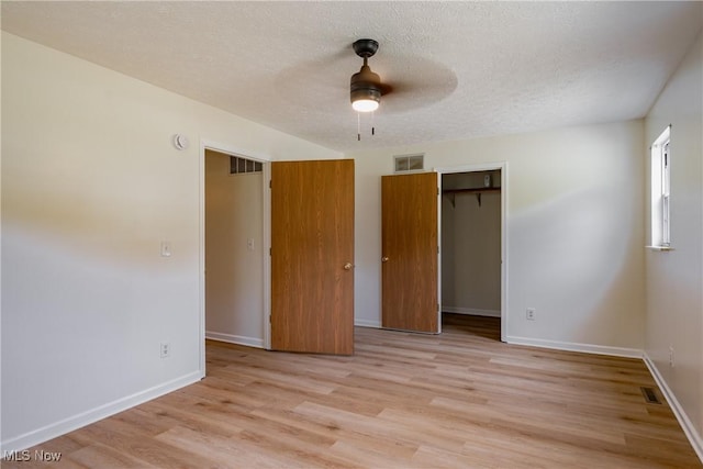 3917 Walker Rd, Walker, WV 26180 - unfurnished bedroom featuring light wood finished floors, a closet, a textured ceiling, and ceiling fan
