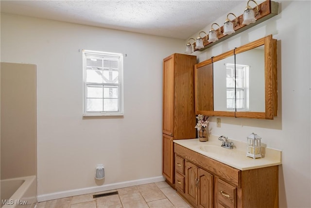 3917 Walker Rd, Walker, WV 26180 - bathroom with vanity, plenty of natural light, a bath, tile patterned floors, and a textured ceiling