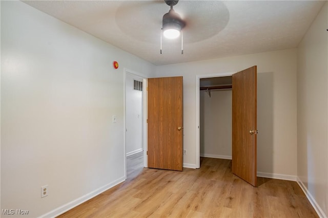 3917 Walker Rd, Walker, WV 26180 - unfurnished bedroom featuring light wood-type flooring, a closet, and ceiling fan