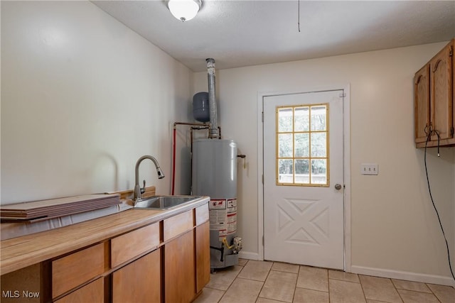 3917 Walker Rd, Walker, WV 26180 - kitchen with water heater, light tile patterned floors, light countertops, and brown cabinets