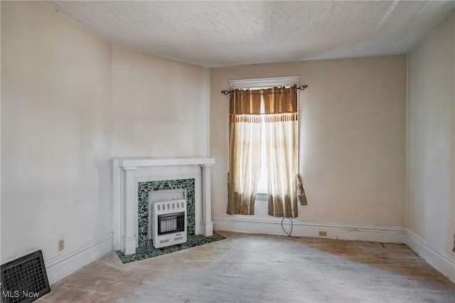 1407 Andrew St, Parkersburg, WV 26101 - unfurnished living room with heating unit, a textured ceiling, a fireplace, and carpet flooring