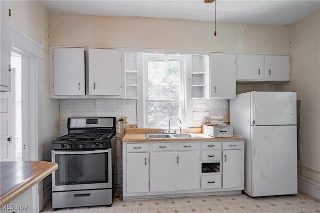 1407 Andrew St, Parkersburg, WV 26101 - kitchen with open shelves, stainless steel range with gas stovetop, freestanding refrigerator, and light flooring
