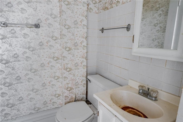 1407 Andrew St, Parkersburg, WV 26101 - half bath with vanity, wallpapered walls, tasteful backsplash, and tile walls