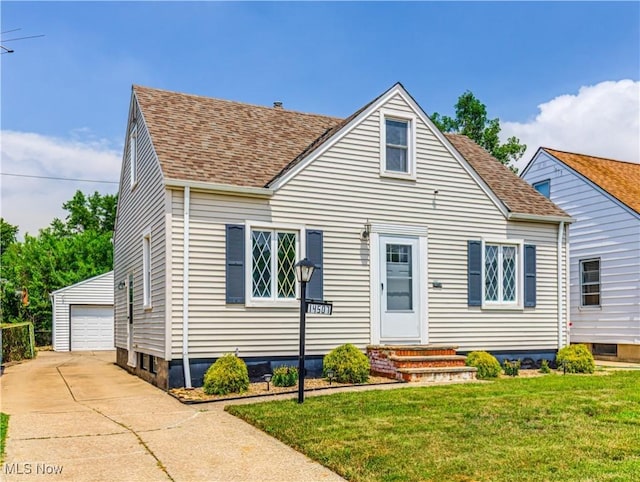 14507 Reddington Ave, Maple Heights, OH 44137 - view of front of property featuring an outbuilding, a shingled roof, a front yard, and a detached garage