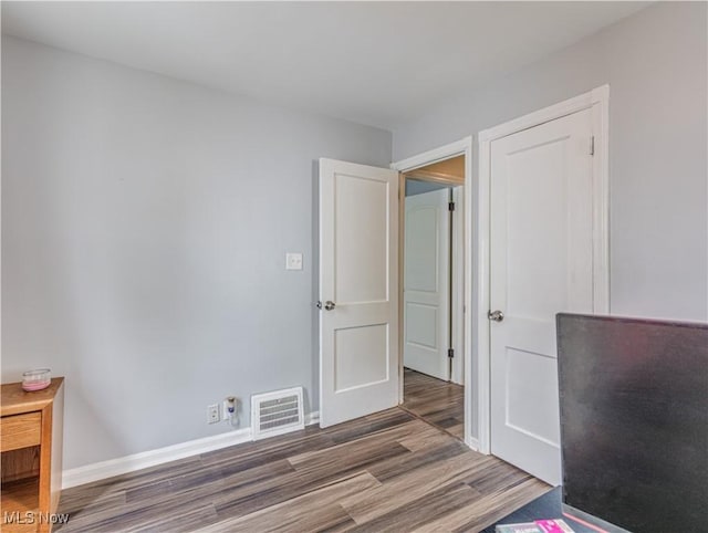 14507 Reddington Ave, Maple Heights, OH 44137 - unfurnished bedroom with wood finished floors and baseboards