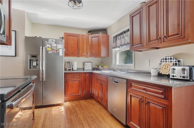 1300 Andrew Ave, Salem, OH 44460 - kitchen with appliances with stainless steel finishes, light wood-style floors, and brown cabinetry