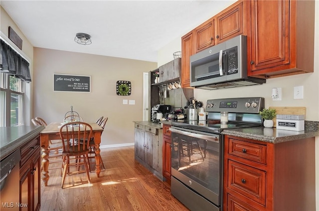 1300 Andrew Ave, Salem, OH 44460 - kitchen with stainless steel appliances, wood finished floors, dark countertops, and brown cabinets