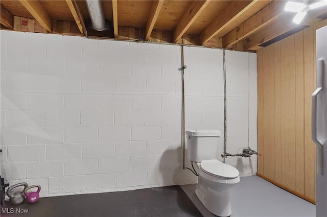 1300 Andrew Ave, Salem, OH 44460 - bathroom featuring finished concrete flooring, concrete block wall, and wooden walls