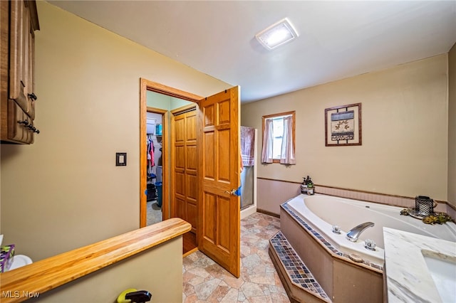 5050 Middle Rd, Conneaut, OH 44030 - full bathroom featuring a garden tub, a walk in closet, and a stall shower