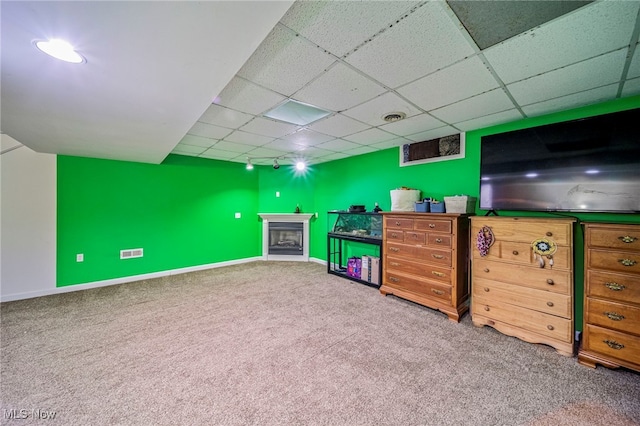 5050 Middle Rd, Conneaut, OH 44030 - living room featuring carpet flooring, a drop ceiling, and a fireplace