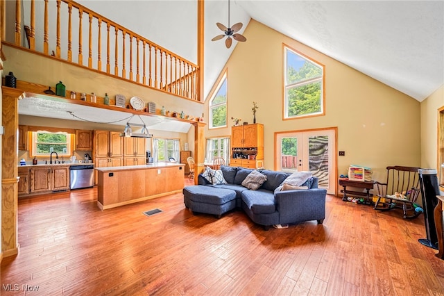 5050 Middle Rd, Conneaut, OH 44030 - living area with high vaulted ceiling, a ceiling fan, light wood finished floors, french doors, and healthy amount of natural light