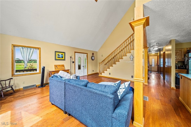 5050 Middle Rd, Conneaut, OH 44030 - living area with light wood-style flooring, stairs, and lofted ceiling