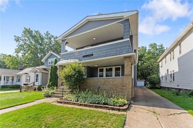 14317-14319 Bayes Ave, Lakewood, OH 44107 - view of front of house featuring brick siding, a front yard, and a balcony