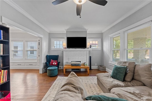 14317-14319 Bayes Ave, Lakewood, OH 44107 - living room with a ceiling fan, wood finished floors, a brick fireplace, and ornamental molding
