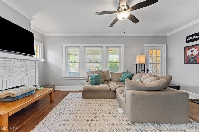 14317-14319 Bayes Ave, Lakewood, OH 44107 - living area featuring ornamental molding, dark wood-type flooring, ceiling fan, and a brick fireplace