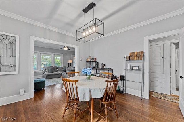 14317-14319 Bayes Ave, Lakewood, OH 44107 - dining room with dark wood-type flooring, ornamental molding, ceiling fan, and a chandelier