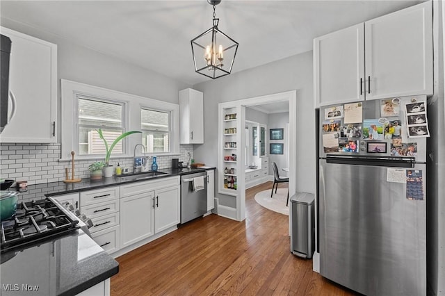 14317-14319 Bayes Ave, Lakewood, OH 44107 - kitchen featuring appliances with stainless steel finishes, decorative backsplash, and white cabinets