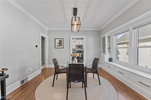 14317-14319 Bayes Ave, Lakewood, OH 44107 - dining room featuring crown molding and dark wood-style flooring