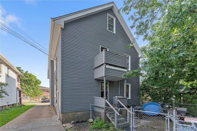 14317-14319 Bayes Ave, Lakewood, OH 44107 - rear view of property featuring a balcony and a gate
