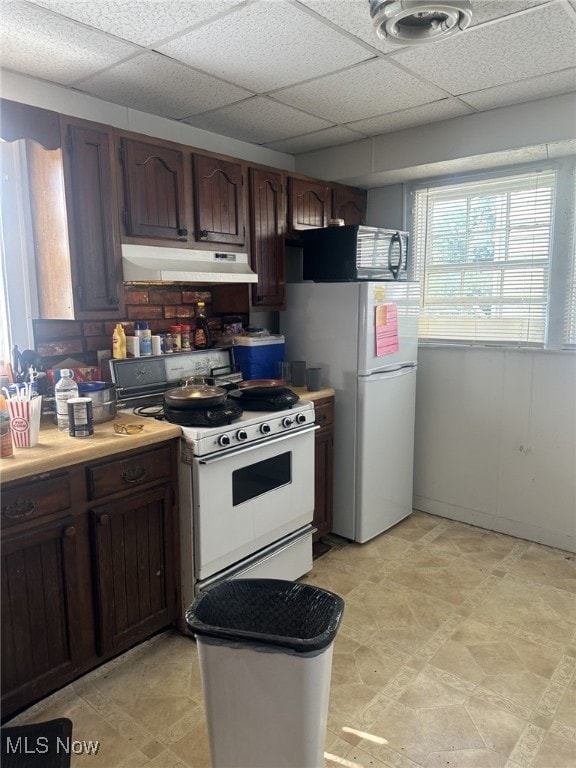 1720 Spring St, Parkersburg, WV 26101 - kitchen featuring under cabinet range hood, white appliances, a paneled ceiling, and light countertops