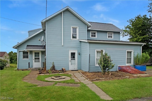 45 Mechanic St, Berlin Heights, OH 44814 - back of property with a fire pit, a lawn, and roof with shingles