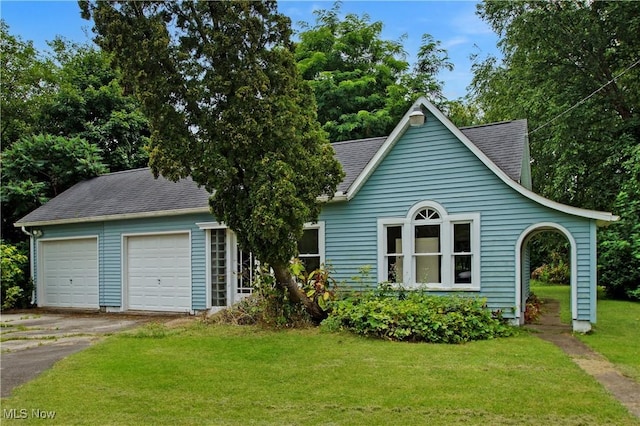 45 Mechanic St, Berlin Heights, OH 44814 - view of front facade featuring a front yard, roof with shingles, and a garage