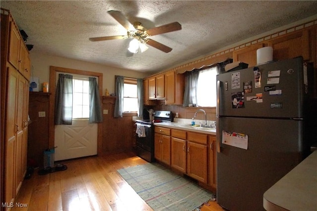 45 Mechanic St, Berlin Heights, OH 44814 - kitchen featuring freestanding refrigerator, black range with electric cooktop, a textured ceiling, light wood-type flooring, and a ceiling fan