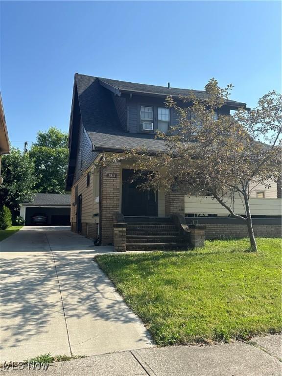 7911 Snow Rd, Parma, OH 44129 - view of front facade featuring brick siding and a front yard