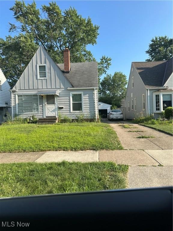5803 Morningside Dr, Parma, OH 44129 - view of front of property featuring a chimney, board and batten siding, and driveway