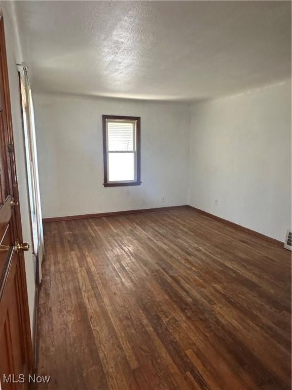 5252 W 45th St, Parma, OH 44134 - empty room with dark wood-style flooring and a textured ceiling