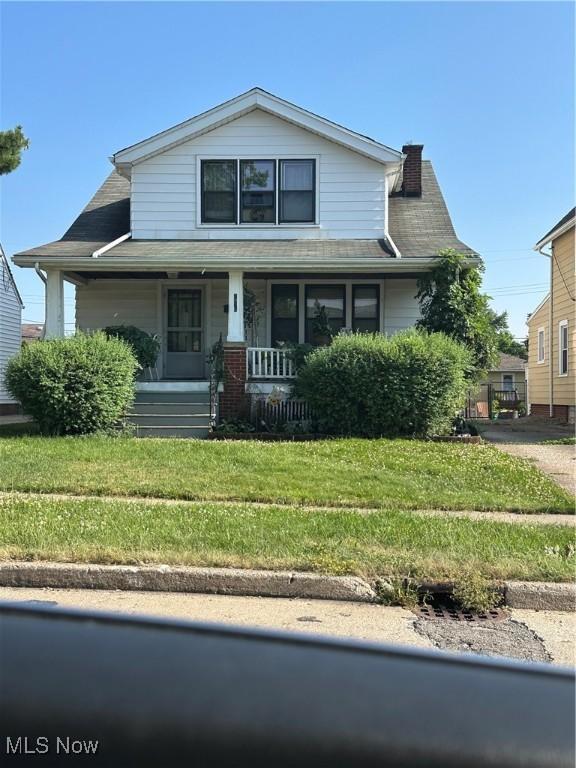 7915 Liberty Ave, Parma, OH 44129 - view of front of property with a porch, a chimney, and a front yard