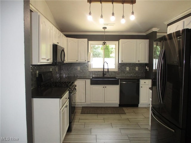 7527 Tamkrist Trl, Conneaut, OH 44030 - kitchen with black appliances, dark countertops, decorative backsplash, white cabinetry, and crown molding