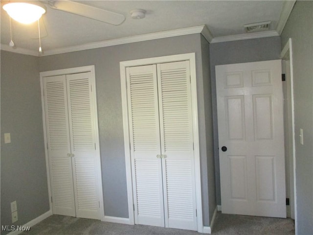 7527 Tamkrist Trl, Conneaut, OH 44030 - unfurnished bedroom with carpet, crown molding, two closets, and a ceiling fan