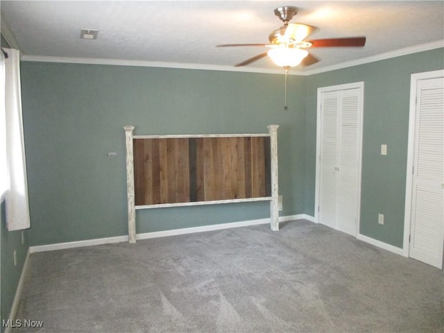 7527 Tamkrist Trl, Conneaut, OH 44030 - unfurnished bedroom featuring carpet floors, multiple closets, crown molding, and ceiling fan