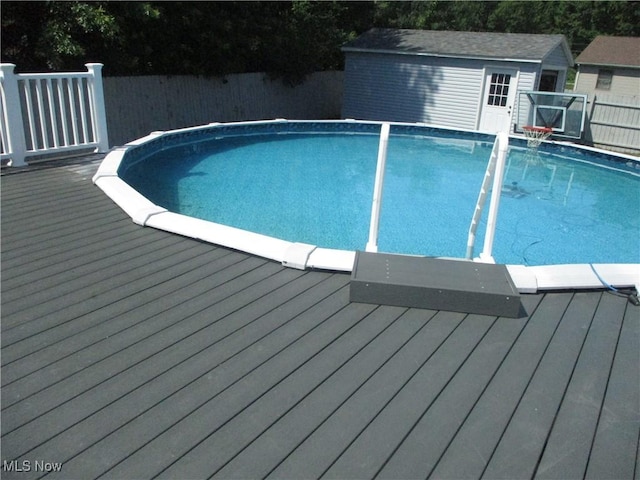 7527 Tamkrist Trl, Conneaut, OH 44030 - view of pool with a deck, a fenced backyard, and an outbuilding