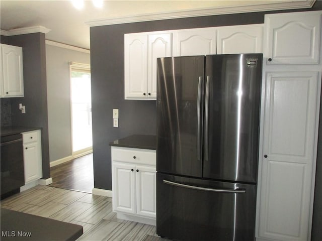 7527 Tamkrist Trl, Conneaut, OH 44030 - kitchen with freestanding refrigerator, ornamental molding, white cabinetry, dark countertops, and dishwashing machine