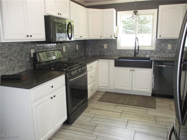 7527 Tamkrist Trl, Conneaut, OH 44030 - kitchen with appliances with stainless steel finishes, dark countertops, tasteful backsplash, white cabinets, and crown molding