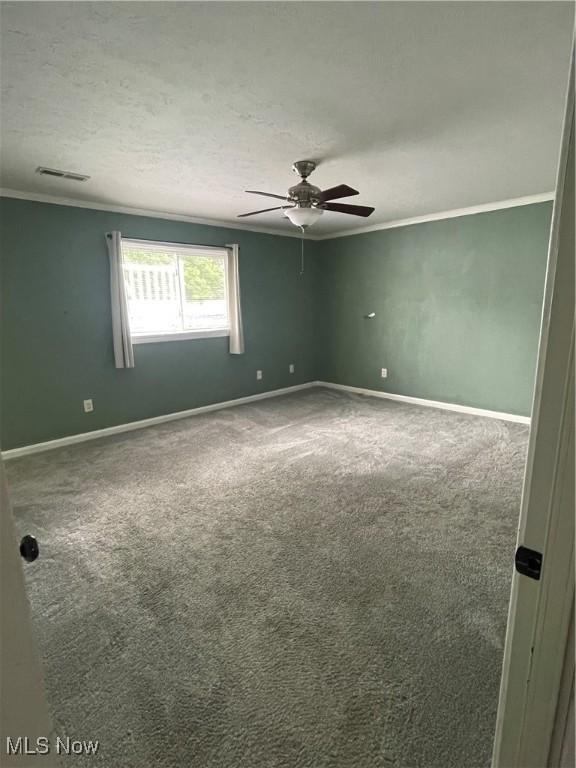 7527 Tamkrist Trl, Conneaut, OH 44030 - unfurnished room with crown molding, a ceiling fan, and carpet flooring