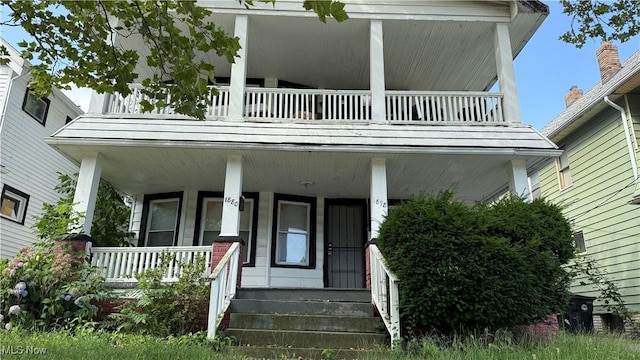 view of front of home with a balcony and a porch