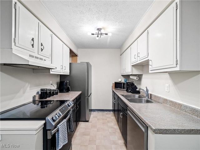 8455 N Akins Rd Unit 103, North Royalton, OH 44133 - kitchen featuring appliances with stainless steel finishes, under cabinet range hood, white cabinetry, a textured ceiling, and light countertops