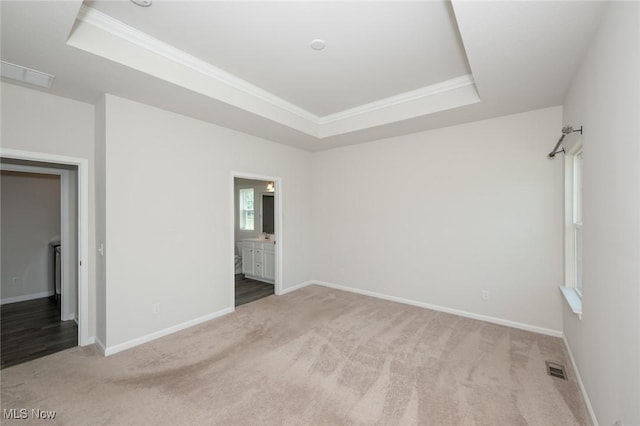 1637 Duncan Way, Streetsboro, OH 44241 - unfurnished bedroom with a raised ceiling, carpet floors, crown molding, and connected bathroom