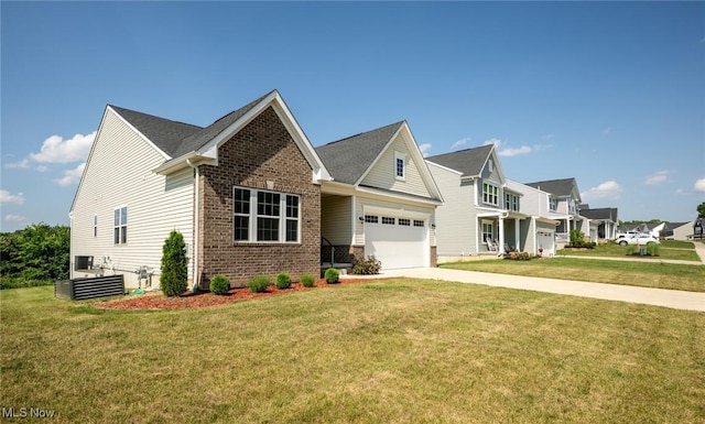 1637 Duncan Way, Streetsboro, OH 44241 - view of front of property with brick siding, concrete driveway, a front yard, and an attached garage