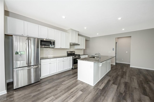 1637 Duncan Way, Streetsboro, OH 44241 - kitchen with appliances with stainless steel finishes, dark wood-style flooring, an island with sink, decorative backsplash, and under cabinet range hood