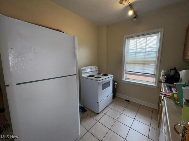 15610 Van Aken Blvd Unit 5, Shaker Heights, OH 44120 - kitchen with white appliances, light tile patterned flooring, and rail lighting