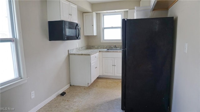 20737 Bowling Green Rd, Maple Heights, OH 44137 - kitchen featuring black appliances, white cabinets, and light countertops