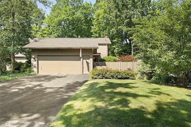 629-37 Fairington Oval, Aurora, OH 44202 - view of front facade featuring driveway, an attached garage, roof with shingles, and a chimney
