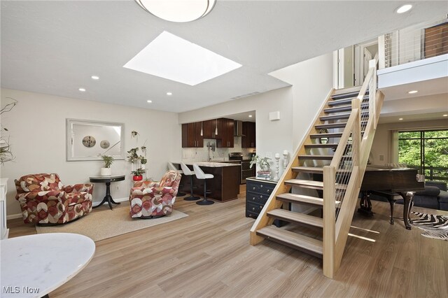 629-37 Fairington Oval, Aurora, OH 44202 - stairway featuring wood finished floors, recessed lighting, and a skylight